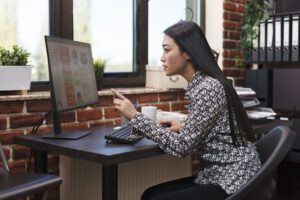 focused financial agency businesswoman reviewing startup management plan chart and project marketing strategy finance company employee analyzing startup audit results while in modern workspace